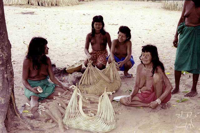 Three generations of Ramkokamekrá Canela women begin to process manioc. photo: Jean Crocker, 1990.
